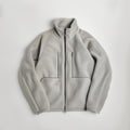 Light gray fleece jacket with high collar, full front zip, two zip chest pockets, and two side pockets—shown laid flat on white. Perfect for pairing with (Sample) Coconut Bar Soap or your favorite organic coconut oil.