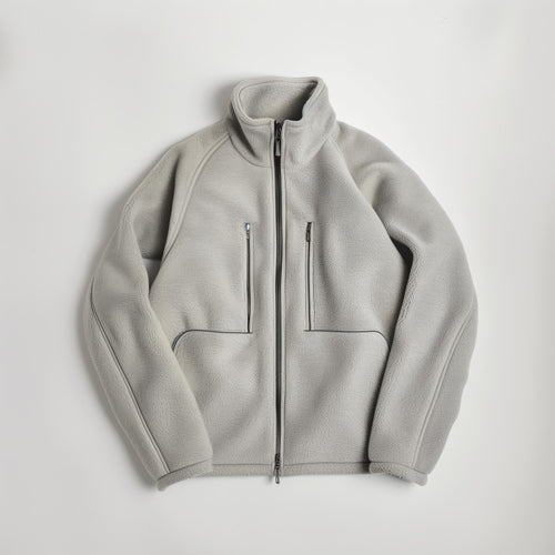 Light gray fleece jacket with high collar, full front zip, two zip chest pockets, and two side pockets—shown laid flat on white. Perfect for pairing with (Sample) Coconut Bar Soap or your favorite organic coconut oil.